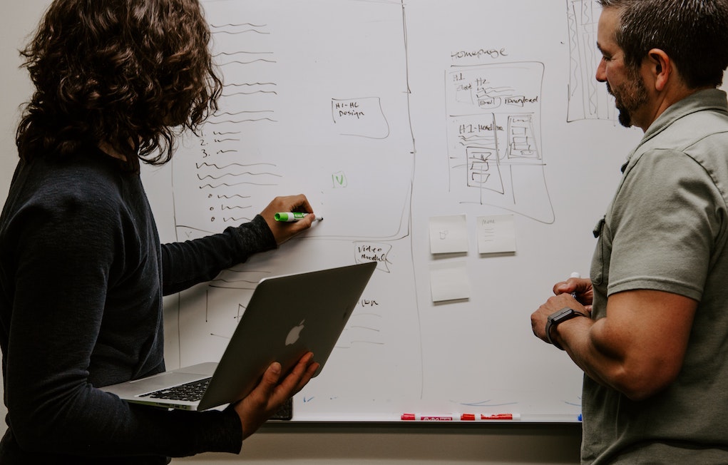 Two people at a whiteboard